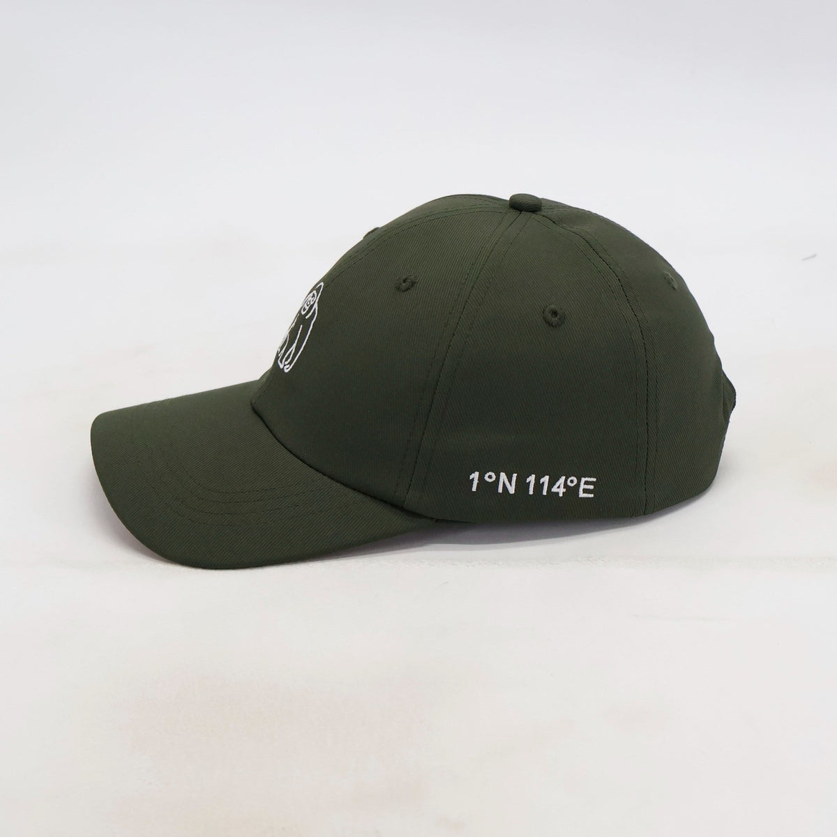 Side view of the ATERRA Forest Series cap showing Borneo coordinates